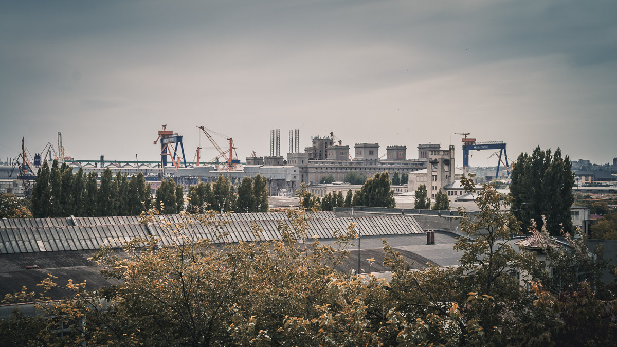 Large cranes and buildings in the port.