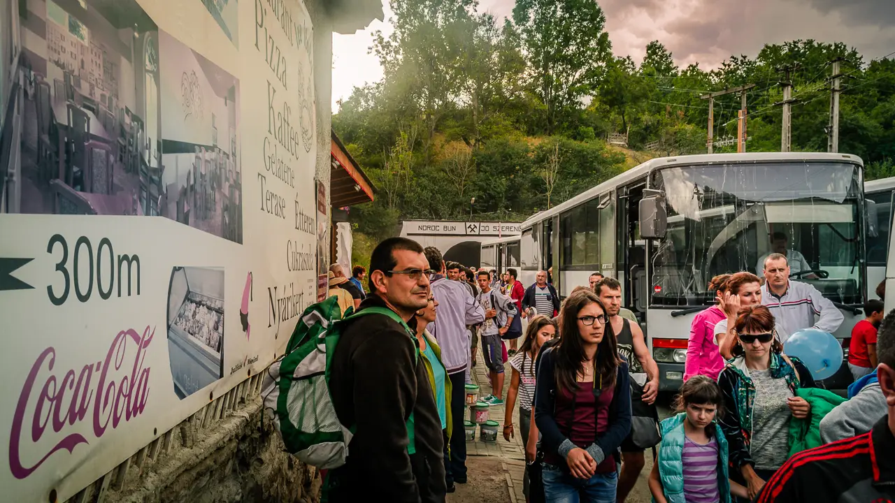 Tourists disembark from the buses near the salt mine entrance.